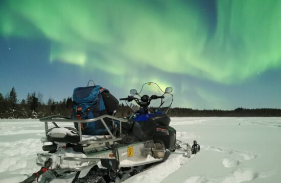 Northern Lights by Snowmobile